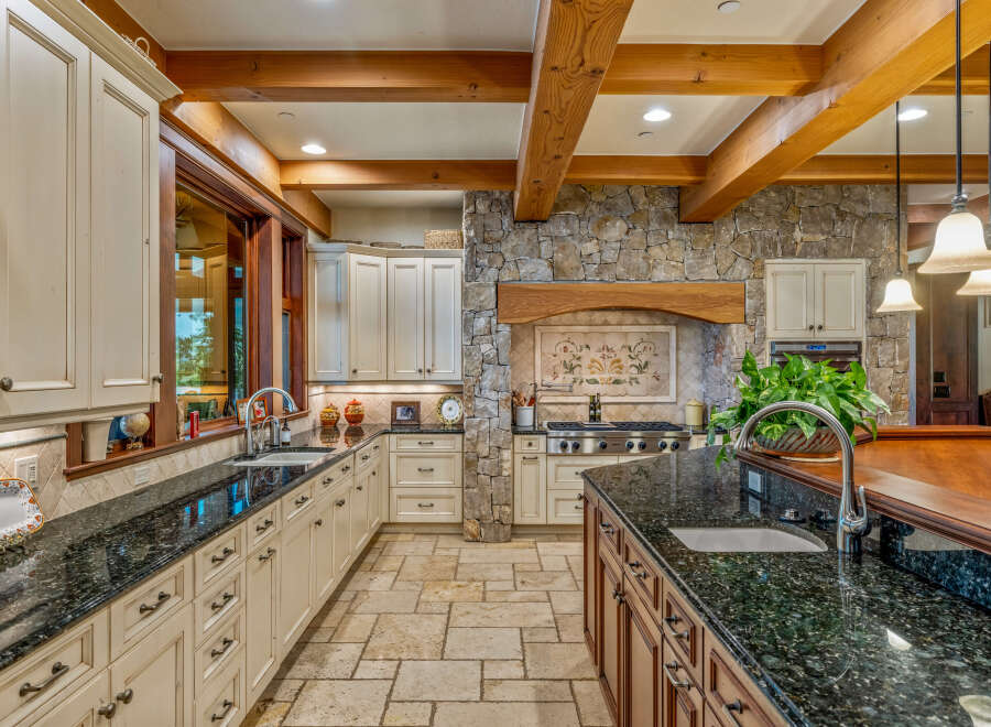 This stunning kitchen boasts a luxurious design with custom cabinetry and granite countertops.