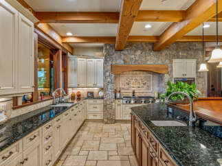 This stunning kitchen boasts a luxurious design with custom cabinetry and granite countertops.