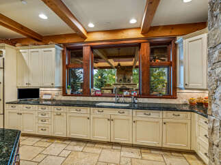 This stunning kitchen boasts a warm and inviting atmosphere, perfect for culinary creations and gatherings.
