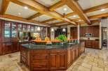 This stunning kitchen boasts a luxurious design with rich wood cabinetry and a spacious island.