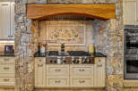 Step into culinary excellence with this stunning kitchen, featuring a Wolf range and custom cabinetry.