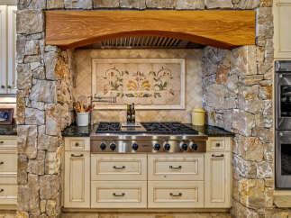 Step into culinary excellence with this stunning kitchen, featuring a Wolf range and custom cabinetry.