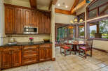 Step into luxury with this stunning kitchen and dining area! Featuring rich wood cabinetry, a sleek granite countertop, and a modern microwave, this space is perfect for both cooking and entertaining.