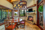 Experience the warmth and charm of this stunning dining room, featuring a cozy fireplace and an inviting round table.
