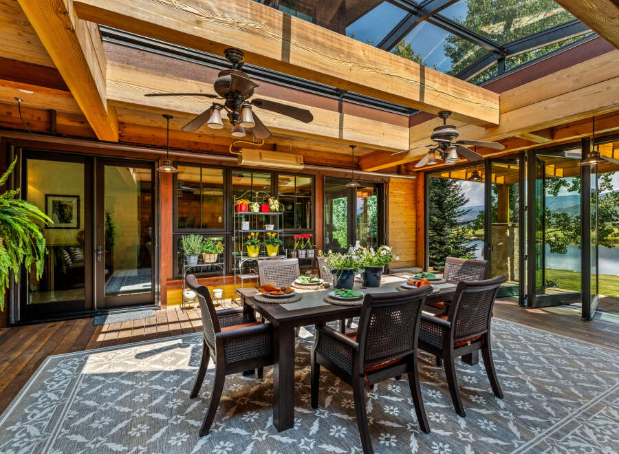 Experience luxury living in this stunning property, featuring a beautiful outdoor dining area.