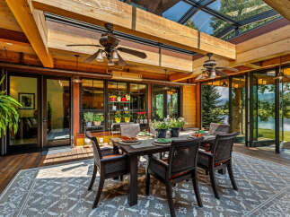 Experience luxury living in this stunning property, featuring a beautiful outdoor dining area.