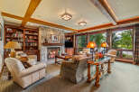 Experience luxury living in this stunning property featuring a cozy living room with a stone fireplace, perfect for relaxing evenings.
