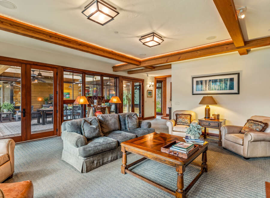Step into luxury with this stunning living room, featuring a cozy sofa and elegant armchairs.