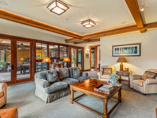 Step into luxury with this stunning living room, featuring a cozy sofa and elegant armchairs.