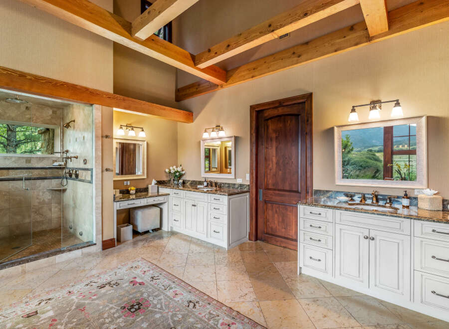 Step into luxury with this stunning bathroom, featuring a spacious walk-in shower and elegant vanity.