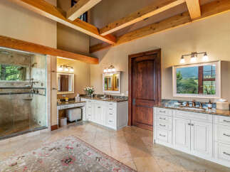 Step into luxury with this stunning bathroom, featuring a spacious walk-in shower and elegant vanity.