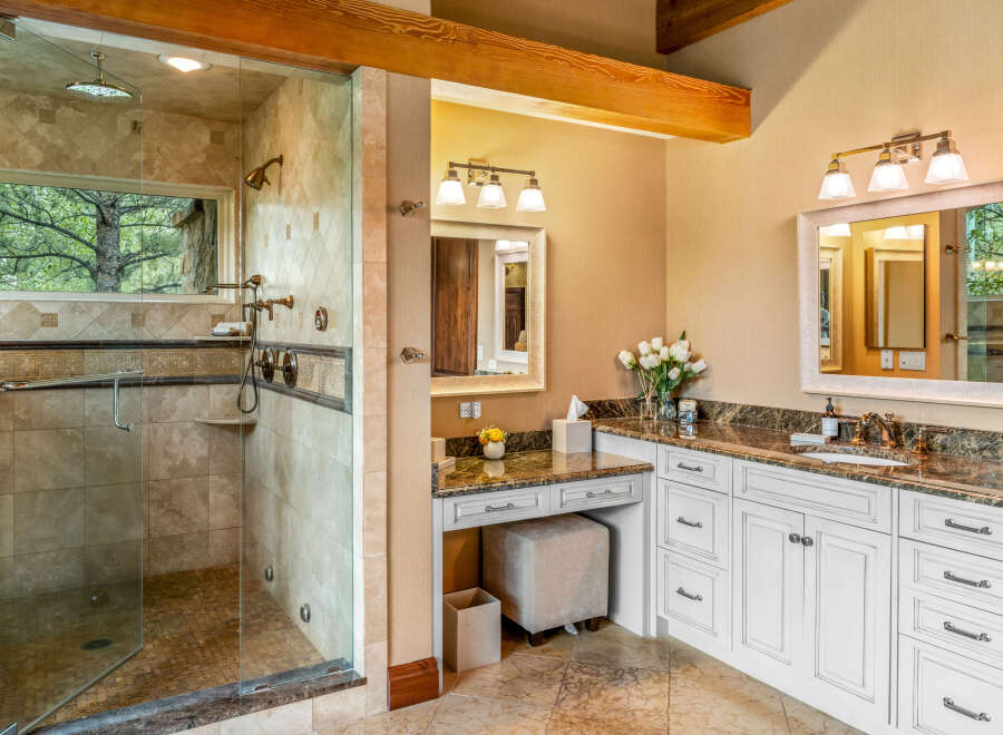 Step into luxury with this stunning bathroom featuring a spacious walk-in shower with a glass enclosure, offering a spa-like experience.