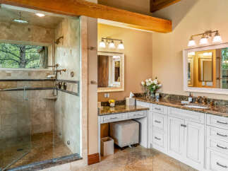 Step into luxury with this stunning bathroom featuring a spacious walk-in shower with a glass enclosure, offering a spa-like experience.