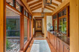 Step into luxury with this stunning hallway, showcasing exquisite wooden beams and elegant lighting fixtures.