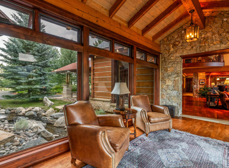 Experience luxury living in this stunning property, featuring a cozy seating area with comfortable leather armchairs.