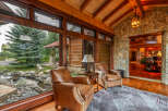 Experience luxury living in this stunning property, featuring a cozy seating area with comfortable leather armchairs.