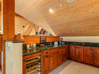 This stunning property boasts a custom-built bar area, perfect for entertaining guests.