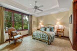 Step into this elegant bedroom, featuring a luxurious brass bed frame and plush bedding.