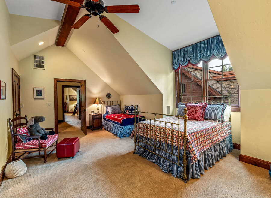 This charming bedroom boasts a cozy atmosphere with its two beds and inviting decor.