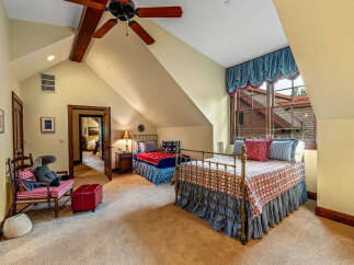 This charming bedroom boasts a cozy atmosphere with its two beds and inviting decor.