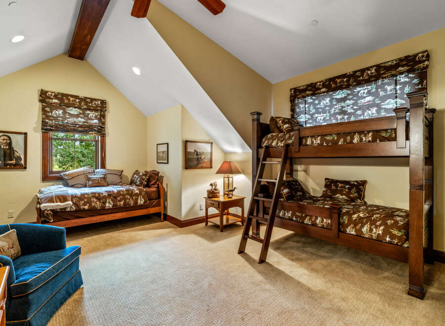 Step into this charming bedroom, featuring a cozy bunk bed and a comfortable single bed, perfect for accommodating guests or family.