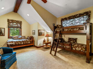 Step into this charming bedroom, featuring a cozy bunk bed and a comfortable single bed, perfect for accommodating guests or family.
