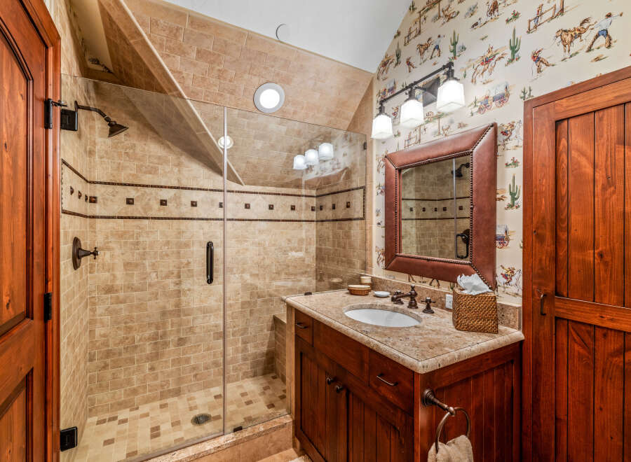 This stunning bathroom features a luxurious walk-in shower with elegant tile work and a frameless glass door.
