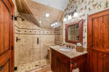 This stunning bathroom features a luxurious walk-in shower with elegant tile work and a frameless glass door.