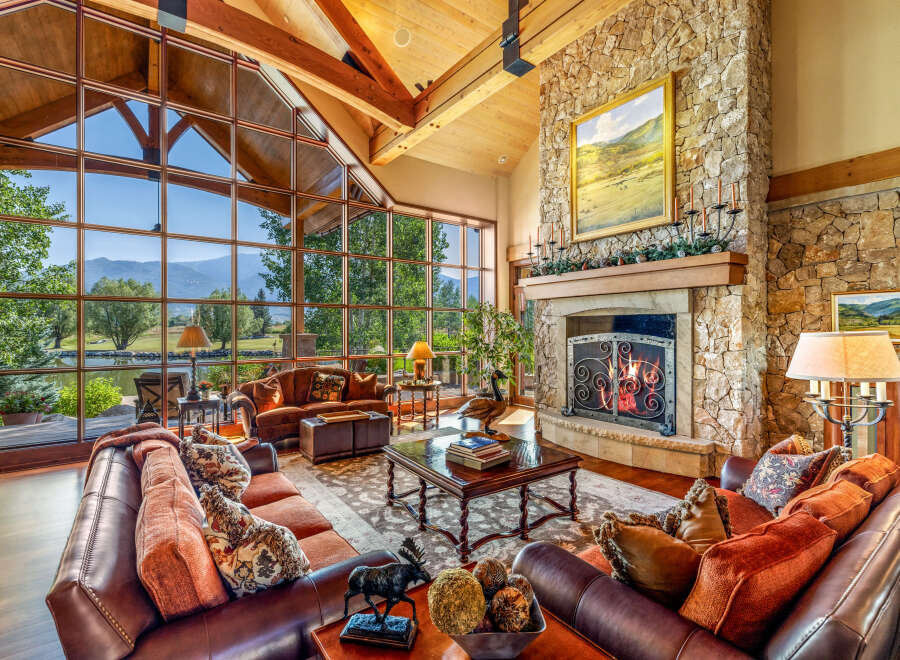 Experience luxury living in this stunning property featuring a grand living room with expansive windows offering breathtaking views.
