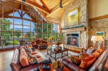 Experience luxury living in this stunning property featuring a grand living room with expansive windows offering breathtaking views.