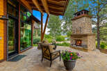 Experience luxury living in this stunning property featuring an outdoor fireplace, perfect for cozy evenings.