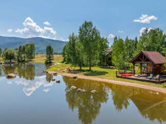 Escape to your dream retreat! This stunning property boasts a serene lake, perfect for waterside relaxation.