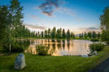 This stunning property features a serene lake surrounded by lush greenery and mature trees, creating a tranquil oasis.