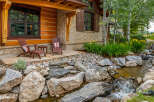 This stunning property boasts a beautiful exterior with a charming wooden facade and stone accents.