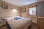 This cozy bedroom features beautiful wooden paneling, creating a warm and inviting atmosphere.