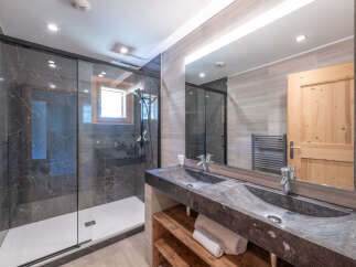 Step into luxury with this stunning bathroom featuring a sleek, modern design.