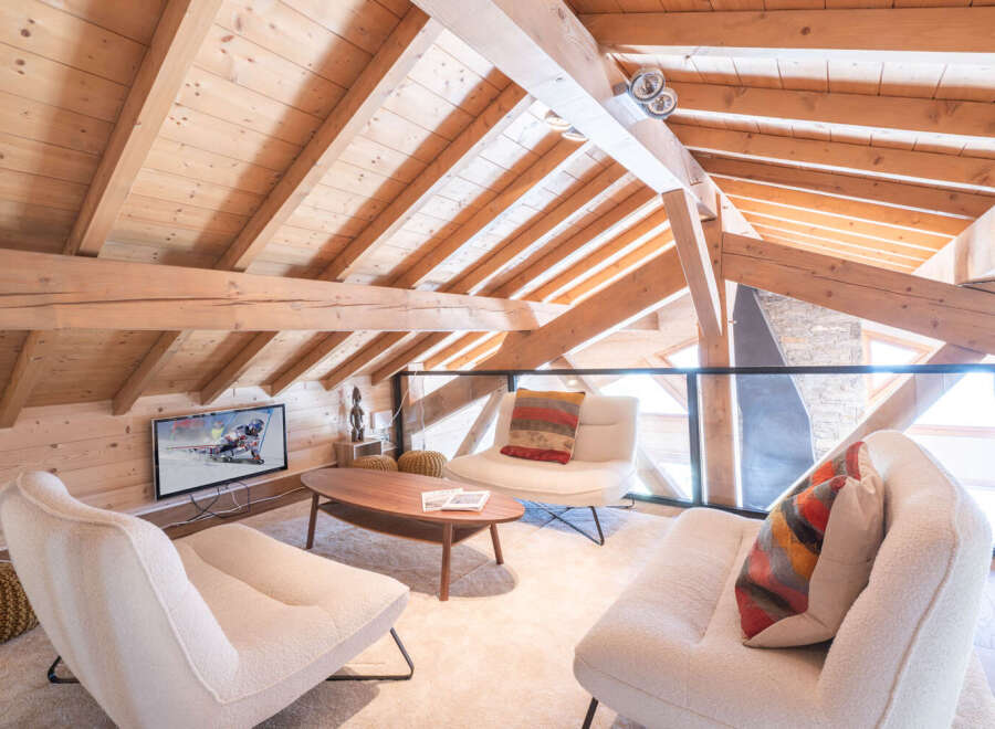 Experience the charm of this stunning loft-style living space, featuring exposed wooden beams and a cozy ambiance.