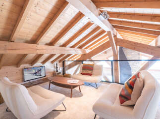 Experience the charm of this stunning loft-style living space, featuring exposed wooden beams and a cozy ambiance.