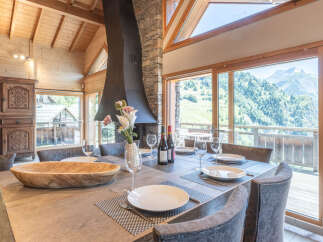 Experience luxury living in this stunning property, featuring a spacious dining area with breathtaking mountain views.