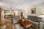 Step into this inviting living space, featuring a cozy seating area with a comfortable sofa and recliner.