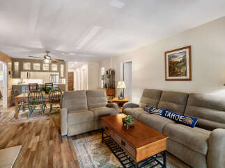 Step into this inviting living space, featuring a cozy seating area with a comfortable sofa and recliner.