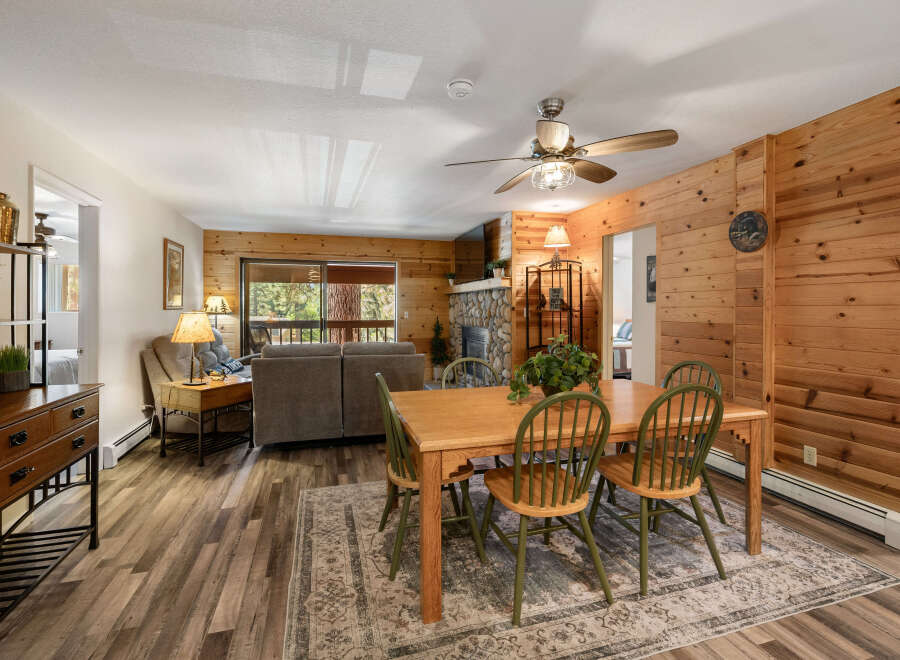 Step into this inviting living space, featuring a cozy fireplace and warm wood paneling that creates a rustic ambiance.