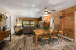 Step into this inviting living space, featuring a cozy fireplace and warm wood paneling that creates a rustic ambiance.