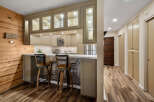 This stunning kitchen features a stylish bar area, perfect for entertaining guests.