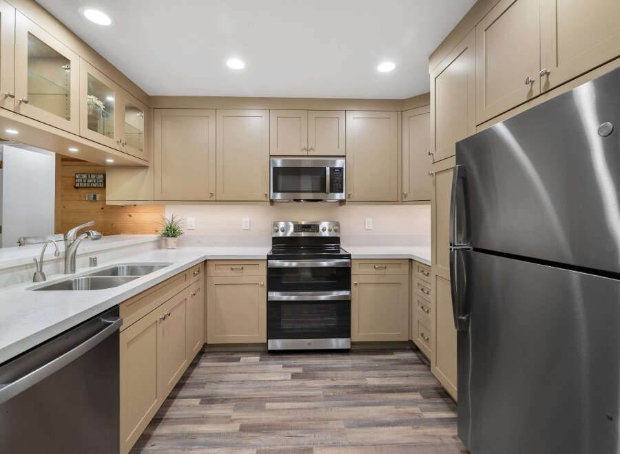 This stunning kitchen boasts modern appliances and ample cabinet space, perfect for culinary enthusiasts.