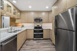 This stunning kitchen boasts modern appliances and ample cabinet space, perfect for culinary enthusiasts.