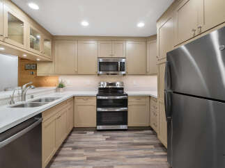 This stunning kitchen boasts modern appliances and ample cabinet space, perfect for culinary enthusiasts.