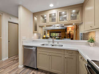 This stunning kitchen boasts a modern design with sleek countertops and ample cabinet space.