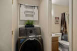 This charming property features a convenient laundry area with a modern GE Profile washer and dryer, complemented by stylish storage.