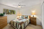 This cozy bedroom features a comfortable bed with a rustic quilt and matching pillows, perfect for a relaxing retreat.